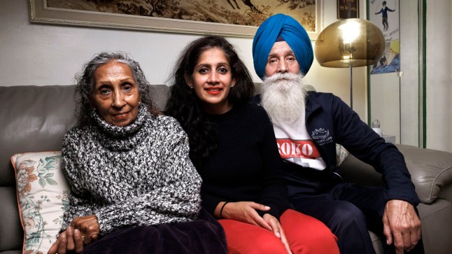 Minreet Kaur, who lives at home in London, is pictured with her parents on the sofa